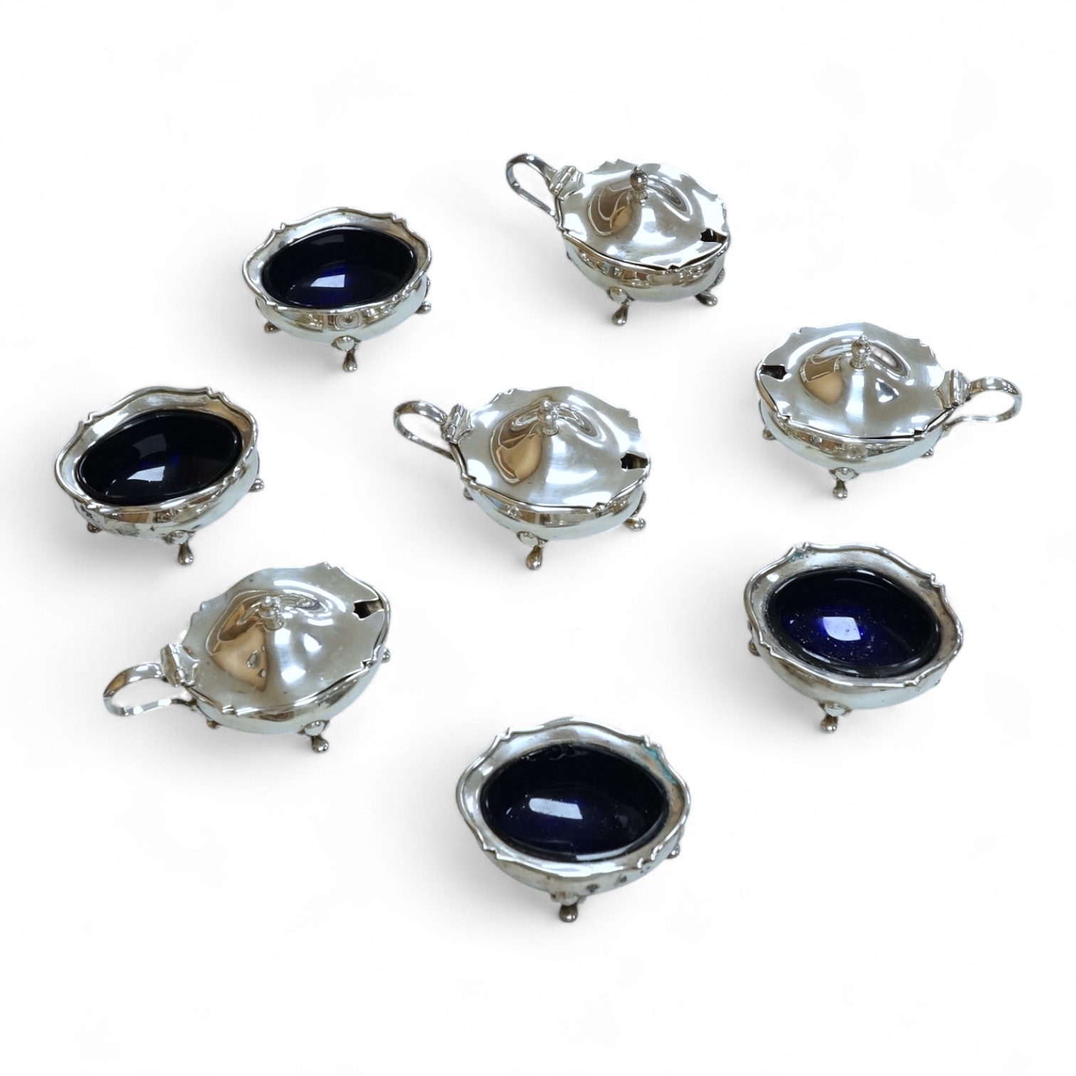 A George V eight piece silver cruet set by Walker & Hall, Birmingham, 1923, lacking spoons.